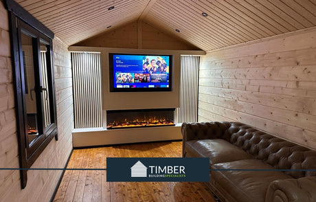 Modern log cabin interior with timber walls, fireplace, TV, and leather sofa