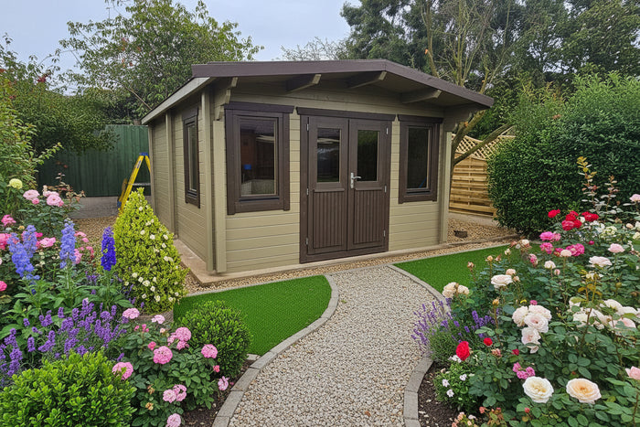 Wooden garden shed with brown doors and windows, surrounded by greenery and flowers.