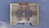Top-down view of a dining area with a table and chairs on a textured blue floor. Long ridge roof and interlocking timber logs on Bowland modern 4x3m garden cabin
