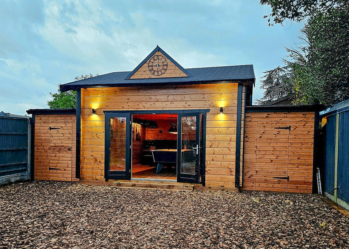 Wooden cabin with a dark roof in a garden setting