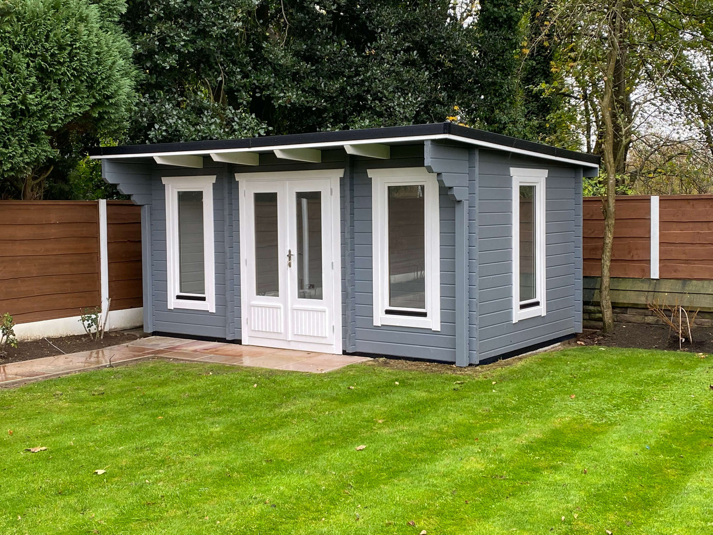 log_cabin_games_room_and_office in a garden by Timber Building Specialists